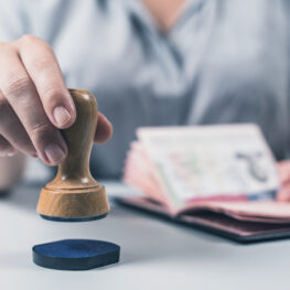 Immigration and passport control at the airport. woman border control officer puts a stamp in the US passport of american citizen. Concept